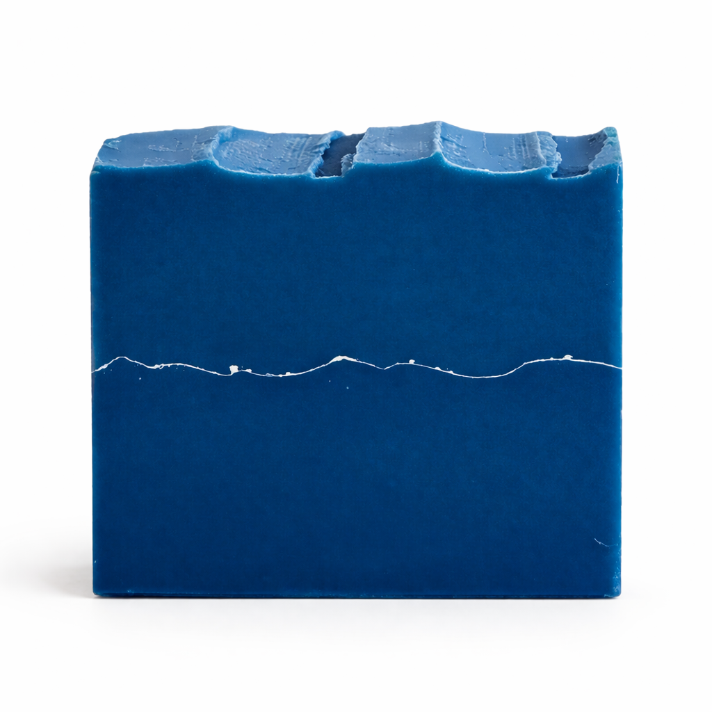 Blue soap bar with a silver line on the middle of the bar on white background
