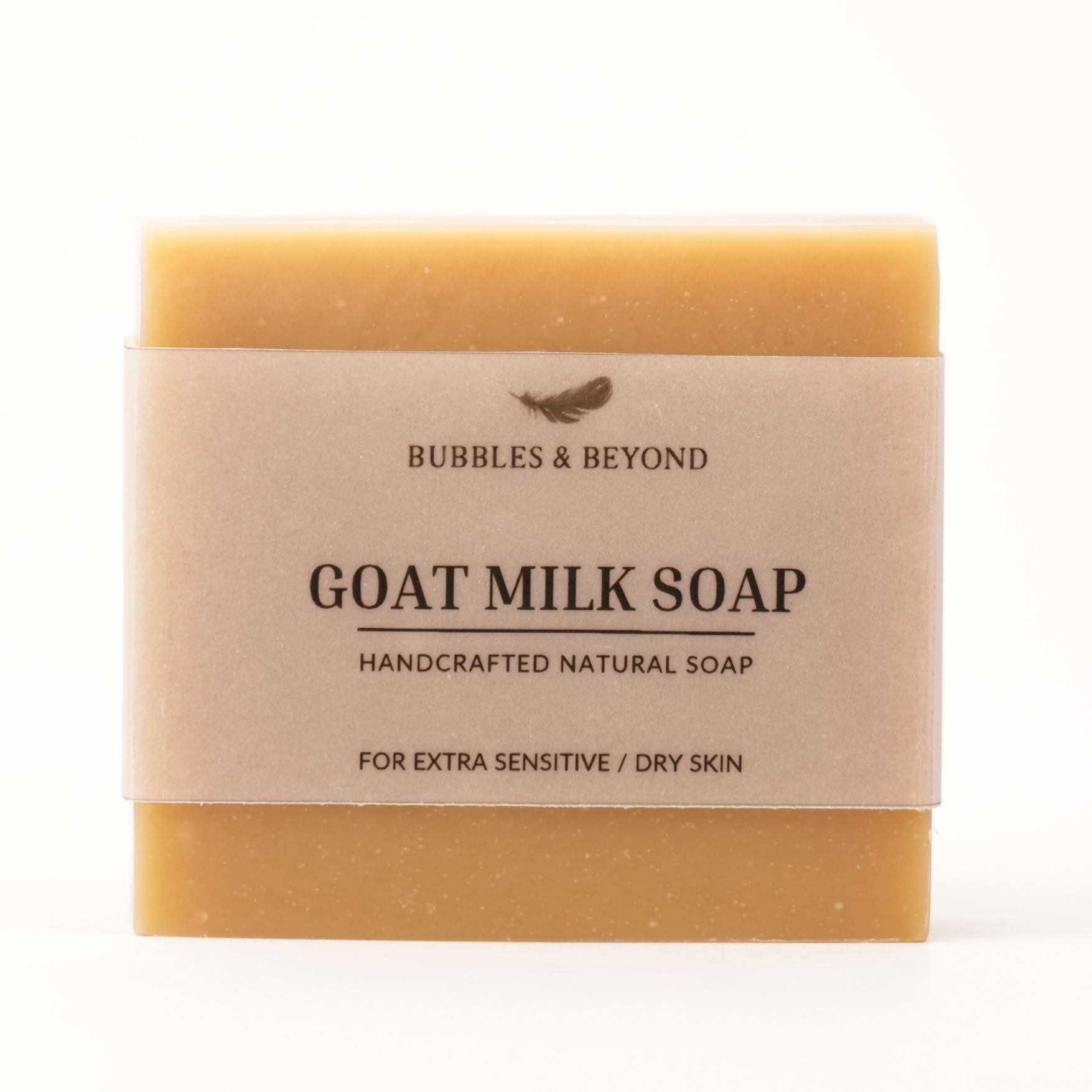 Bar of goat milk soap with a transparent label on a white background