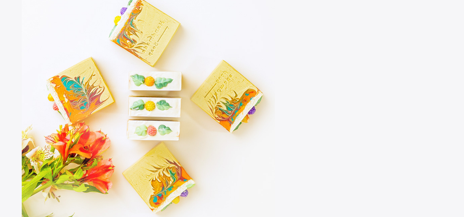 Colorful soap bars with floral designs on a white background