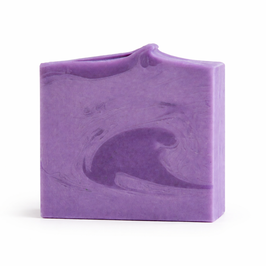 Purple soap bar with a wavy texture on a white background